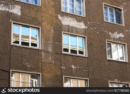 Urban building facade with windows and reflections