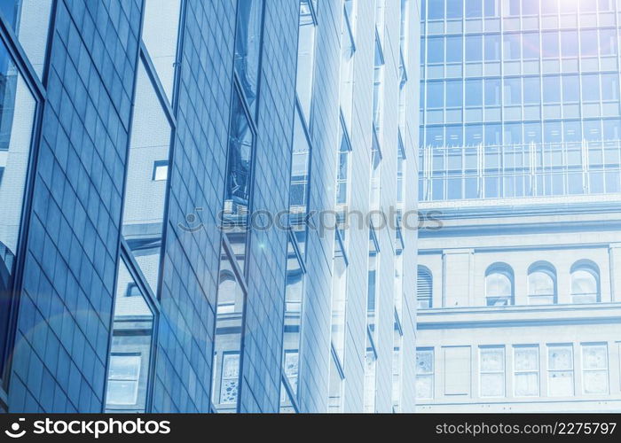 urban business office building glass windows in large metro city blue color tone for background