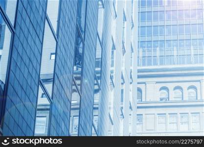 urban business office building glass windows in large metro city blue color tone for background