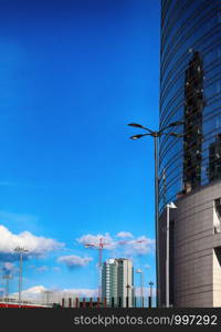 urban construction. Crane and building construction site against blue sky