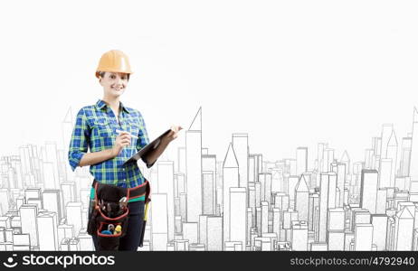 Urban construction. Young woman builder with folder in hand