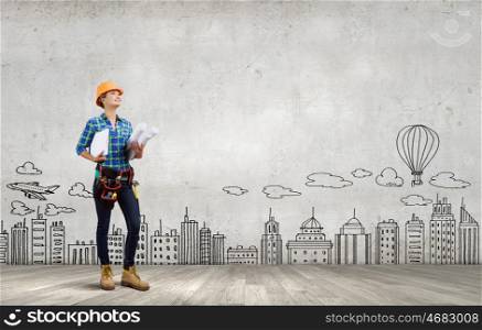 Urban construction. Young woman builder with projects in hand