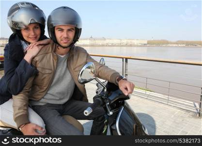 Urban couple on a scooter