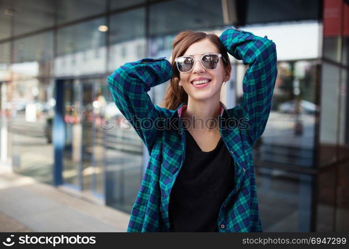 Urban fashionable girl posing outdoors in the city. Urban fashionable girl posing outdoors in the city.