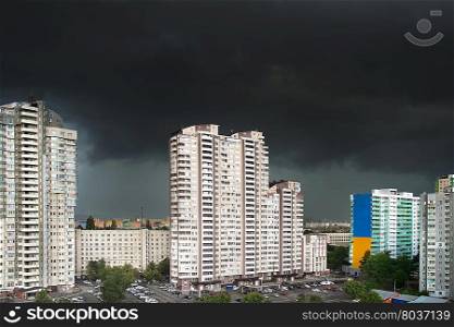 Urban landscape with black stormy clouds in th sky