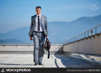 urban outdoor portrait of middle aged senior business man