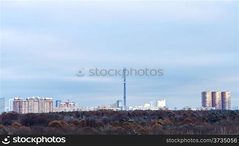 urban panorama with low winter clouds over city and tv tower