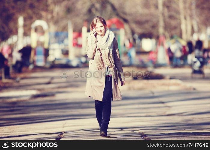 Urban portrait of a happy woman in coat