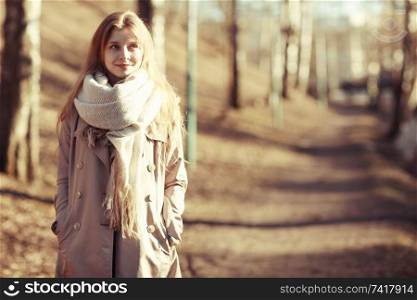 Urban portrait of a happy woman in coat