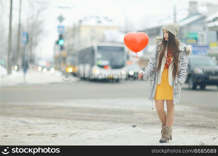 Urban portrait of a young girl outside in winter