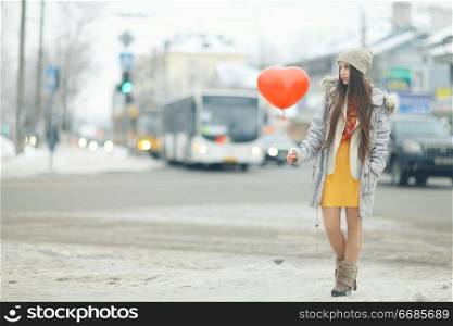 Urban portrait of a young girl outside in winter