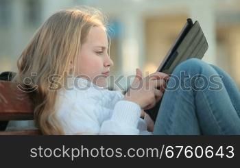 Urban Scene - Child Using Touch Screen Tablet PC