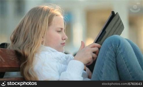 Urban Scene - Child Using Touch Screen Tablet PC