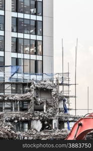 Urban scene. Dismantling of a house. Ruins of building under destruction in city center. Industry.