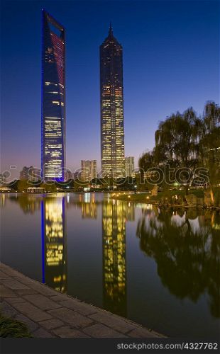 Urban skyscrapers reflected in river