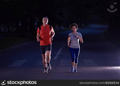 urban sports, healthy couple jogging in the city at early morning in night
