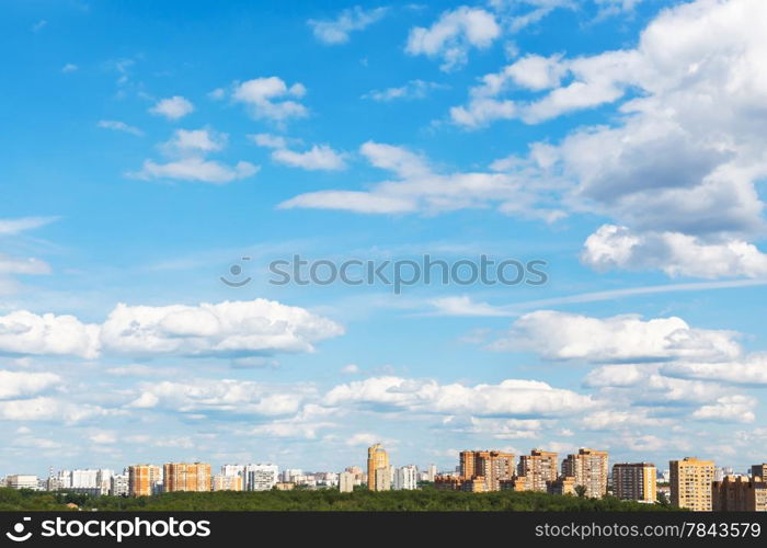 urban street under blue sky with fluffy clouds in spring