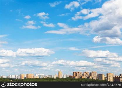 urban street under blue sky with fluffy clouds in spring