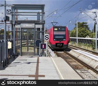 Urban train approaches the platform. Copenhagen. Denmark