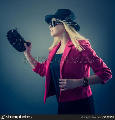 Urbane mature woman wearing a sunglasses and hat, studio shot