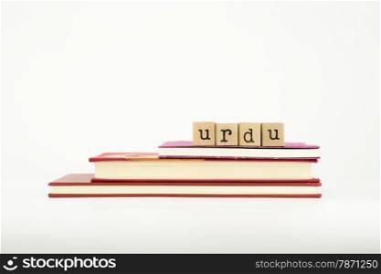 urdu word on wood stamps stack on books, language and study concept
