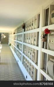 Urns with ashes in a columbarium wall