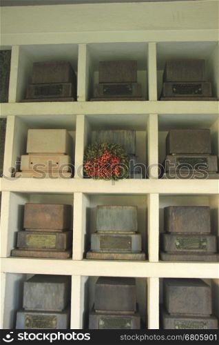 Urns with ashes in a columbarium wall