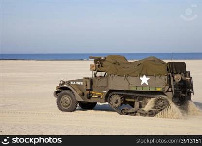 US army halftrack from second world war riding on beach