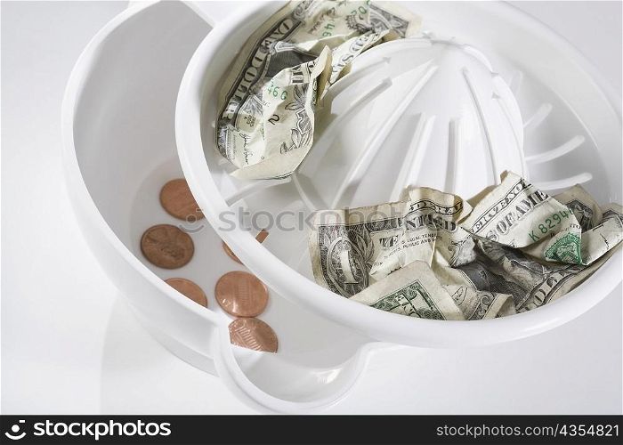 US dollar bills and coins on a juicer