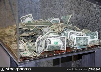 US Dollar in a plexi glass donation box