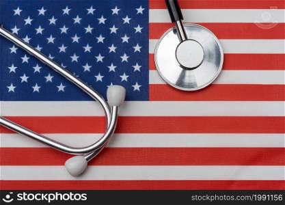 Us flag and stethoscope. The concept of medicine. Stethoscope on the flag in the background.. Us flag and stethoscope. The concept of medicine.