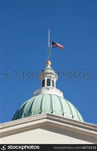 US flag flying at half mast on the saint loius courthouse