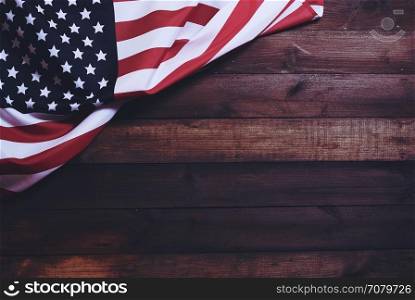 US flag. star striped flag of the USA on rough dark wooden surface with blank space for text