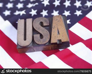 USA in wood type on an American flag