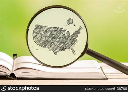 USA information with a pencil drawing of an america map in a magnifying glass