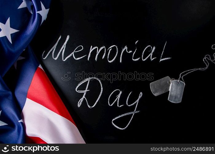 USA Memorial Day concept. American flag and dog tags on a black background. Handwritten lettering on chalkboard.. USA Memorial Day concept. American flag and dog tags on black background. Handwritten lettering on chalkboard.
