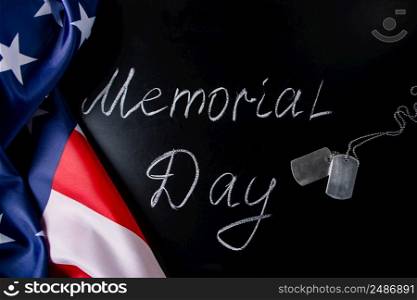 USA Memorial Day concept. American flag and dog tags on a black background. Handwritten lettering on chalkboard.. USA Memorial Day concept. American flag and dog tags on black background. Handwritten lettering on chalkboard.