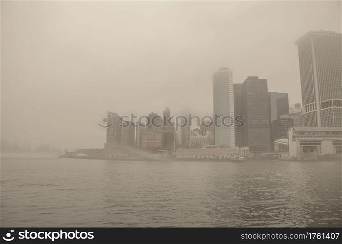 USA. New York City. Manhattan early in the morning. Thick fog. Embankment and skyscrapers.