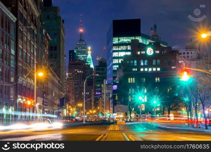 USA, New York City. Night Manhattan. Intersection near Cooper Square, street lights, traffic lights and tracks from car headlights. Night Intersection and Street Lights