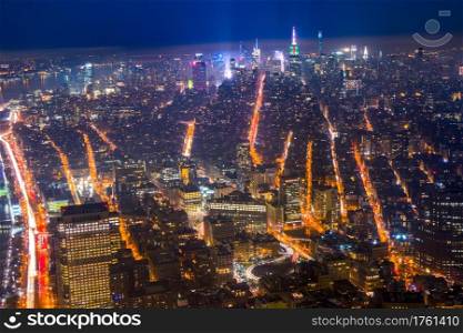USA. New York City. View from the roof of a skyscraper at night city. Buildings and arteries of the streets. Car traffic. Aerial view.