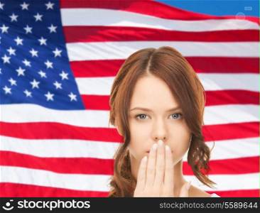 usa politics, conspiracy and secrecy concept - woman with hand over mouth on american flag background