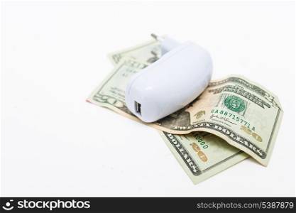 usb-charger over heap of dollar on white background. Economy of energy concept