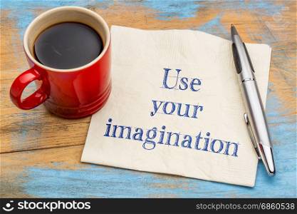 Use your imagination reminder or advice - handwriting on a napkin with a cup of coffee
