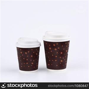 used brown paper cup with plastic cover for hot and cold drinks on a white background