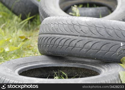 Used, dumped car tyres. Copy space.