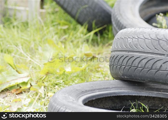 Used, dumped car tyres. Copy space.