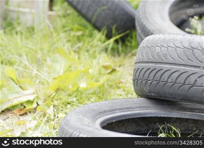 Used, dumped car tyres. Copy space.