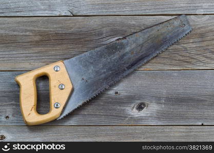 Used Hand saw on rustic wooden boards