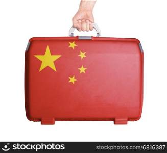 Used plastic suitcase with stains and scratches, printed with flag, China