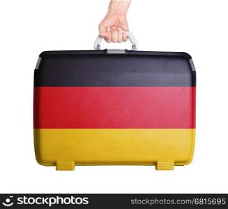 Used plastic suitcase with stains and scratches, printed with flag, Germany